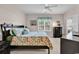 Bright bedroom with floral bedding, natural light, and access to a private balcony at 881 Palmetto Trail # 103, Myrtle Beach, SC 29577