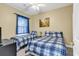 Bedroom featuring two twin beds with blue plaid bedding and a ceiling fan at 881 Palmetto Trail # 103, Myrtle Beach, SC 29577