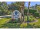 Community entrance sign surrounded by lush landscaping and vibrant flowerbeds at 881 Palmetto Trail # 103, Myrtle Beach, SC 29577