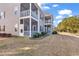 Exterior of home features three screened in back porches and a lawn at 881 Palmetto Trail # 103, Myrtle Beach, SC 29577