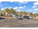 Condominium exterior showcasing tropical landscaping, and ample parking at 881 Palmetto Trail # 103, Myrtle Beach, SC 29577