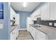 Bright kitchen features white cabinetry, gray countertops, mosaic backsplash, and stainless steel appliances at 881 Palmetto Trail # 103, Myrtle Beach, SC 29577