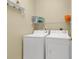 Practical laundry room featuring a washing machine, dryer, and shelving at 881 Palmetto Trail # 103, Myrtle Beach, SC 29577