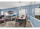 Inviting open-concept features dining area, living room with sofa, and large decorative mirror at 881 Palmetto Trail # 103, Myrtle Beach, SC 29577