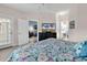 Relaxing bedroom with ceiling fan, tv and doorway to the bathroom and living room at 881 Palmetto Trail # 103, Myrtle Beach, SC 29577