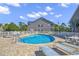 Community pool with lounge chairs and well-maintained fencing at 881 Palmetto Trail # 103, Myrtle Beach, SC 29577
