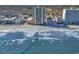 This aerial shows high-rise condos on a sandy beach with ocean views and a small town behind the condos at 912 N Waccamaw Dr. # 1404, Garden City Beach, SC 29576