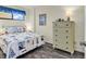 Comfortable bedroom with a queen-size bed, dresser, and nautical-themed decor at 912 N Waccamaw Dr. # 1404, Garden City Beach, SC 29576