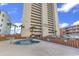 Exterior view of building with swimming pool at 912 N Waccamaw Dr. # 1404, Garden City Beach, SC 29576