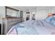 A comfortable bedroom featuring a dresser, queen-size bed, and views of a kitchen space at 912 N Waccamaw Dr. # 1404, Garden City Beach, SC 29576