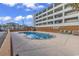 Outdoor swimming pool area near the beach with lounge chairs and seating at 912 N Waccamaw Dr. # 1404, Garden City Beach, SC 29576