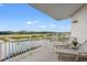 Balcony with lounge chairs overlooking a waterway, golf course and blue sky at 9547 Edgerton Dr. # 301, Myrtle Beach, SC 29572