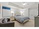 Bedroom with tray ceilings, ceiling fan, and white furniture and bedding at 9547 Edgerton Dr. # 301, Myrtle Beach, SC 29572