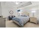 Bedroom with tray ceilings, ceiling fan, and white furniture and bedding at 9547 Edgerton Dr. # 301, Myrtle Beach, SC 29572