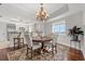 A dining room with a chandelier and a wooden table with seating for six at 9547 Edgerton Dr. # 301, Myrtle Beach, SC 29572