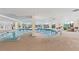 Bright indoor pool area with ample seating and natural light at 9547 Edgerton Dr. # 301, Myrtle Beach, SC 29572