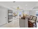 Modern kitchen boasts stainless steel appliances, a breakfast bar, and outdoor views at 9547 Edgerton Dr. # 301, Myrtle Beach, SC 29572