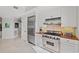 A kitchen with a stainless steel Viking range and refrigerator, and marble floors at 9547 Edgerton Dr. # 301, Myrtle Beach, SC 29572