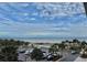 High angle view featuring a community pool, palm trees, parking, and a picturesque sandy beach at 9820 Queensway Blvd. # 303, Myrtle Beach, SC 29572