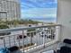 Enjoy beach views from this condo balcony overlooking the ocean and parking area with palm trees at 9820 Queensway Blvd. # 303, Myrtle Beach, SC 29572