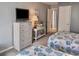 Bedroom with twin beds, dresser, and coastal decor, offering a cozy and inviting space for relaxation at 9820 Queensway Blvd. # 303, Myrtle Beach, SC 29572