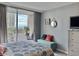 Bedroom with coastal decor, a comfortable seating area, and a balcony offering ocean views at 9820 Queensway Blvd. # 303, Myrtle Beach, SC 29572
