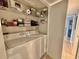 Functional laundry area with stacked washer and dryer, plus shelving for storage at 9820 Queensway Blvd. # 303, Myrtle Beach, SC 29572