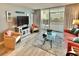 Stylish living room with a TV, comfortable seating, and access to a balcony with views of the city and greenery at 9820 Queensway Blvd. # 303, Myrtle Beach, SC 29572