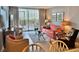 Well-lit living room with plush seating, an entertainment center, and sliding glass doors to the outside at 9820 Queensway Blvd. # 303, Myrtle Beach, SC 29572