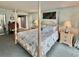Spacious main bedroom featuring a four-poster bed, serene decor, and access to a private ensuite bathroom at 9820 Queensway Blvd. # 303, Myrtle Beach, SC 29572