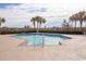 Community pool surrounded by palm trees and greenery, under a sunny sky at 9820 Queensway Blvd. # 303, Myrtle Beach, SC 29572