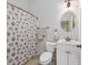 Bright bathroom featuring a vanity, a mirror, and a shower with patterned curtain at 102-A N Poplar Dr., Surfside Beach, SC 29575