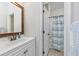 Bathroom featuring a white vanity and framed mirror, with a separate toilet and shower area at 102-A N Poplar Dr., Surfside Beach, SC 29575