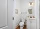 A well-lit half bathroom offering a pedestal sink and toilet at 102-A N Poplar Dr., Surfside Beach, SC 29575