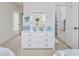 Comfortable bedroom featuring a white dresser with mirror, decor, and a glimpse of twin beds at 102-A N Poplar Dr., Surfside Beach, SC 29575