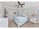 Bright bedroom featuring a ceiling fan and large windows at 102-A N Poplar Dr., Surfside Beach, SC 29575