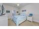 Bright bedroom featuring a queen-size bed with stylish beach-themed bedding and coastal decor at 102-A N Poplar Dr., Surfside Beach, SC 29575