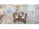 Dining area featuring a glass-topped table and stylish wicker chairs, bathed in natural light at 102-A N Poplar Dr., Surfside Beach, SC 29575