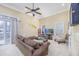 Cozy living room with a ceiling fan, recessed lights, and a large sofa, perfect for relaxation at 102-A N Poplar Dr., Surfside Beach, SC 29575