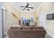 Cozy living room with a ceiling fan, recessed lights, and a large sofa, perfect for relaxation at 102-A N Poplar Dr., Surfside Beach, SC 29575