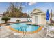 A community pool with a yellow pool house and metal ladders at 102-A N Poplar Dr., Surfside Beach, SC 29575