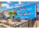 Outdoor dining area with a large mural that says 'Surfside Beach' at 102-A N Poplar Dr., Surfside Beach, SC 29575