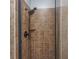 Shower featuring a rainfall showerhead, tile surround, and glass door at 102-A N Poplar Dr., Surfside Beach, SC 29575