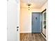 Foyer with wood-look flooring and a blue-painted front door with a decorative key at 10301 N Kings Hwy. # 15-8, Myrtle Beach, SC 29572