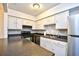 Well lit kitchen with stainless steel refrigerator, white cabinets, and a breakfast bar at 10301 N Kings Hwy. # 15-8, Myrtle Beach, SC 29572