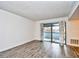 Bright living room featuring wood-look flooring and sliding glass doors with a view at 10301 N Kings Hwy. # 15-8, Myrtle Beach, SC 29572