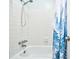 Tiled shower and tub featuring a decorative shower curtain at 10301 N Kings Hwy. # 15-8, Myrtle Beach, SC 29572