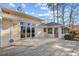 Exterior view of the home, showing the patio and back of home with ample windows and a view of the yard at 1043 Yellow Jasmine Dr., Longs, SC 29568