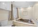 A luxurious bathroom features a tiled surround tub and decorative lighting at 1043 Yellow Jasmine Dr., Longs, SC 29568
