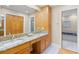 Bright bathroom features a double sink vanity with granite countertop and a linen closet at 1043 Yellow Jasmine Dr., Longs, SC 29568